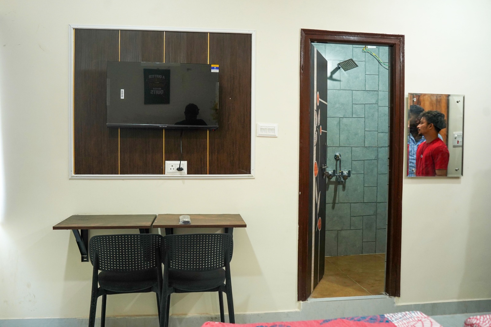 PG room with wall-mounted TV and attached bathroom